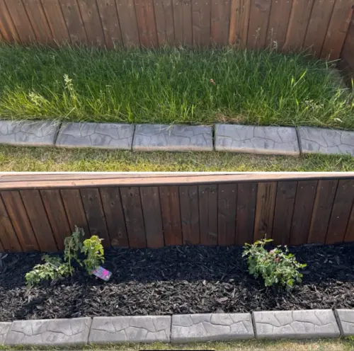 Removed overgrown grass, planted perennials and added mulch